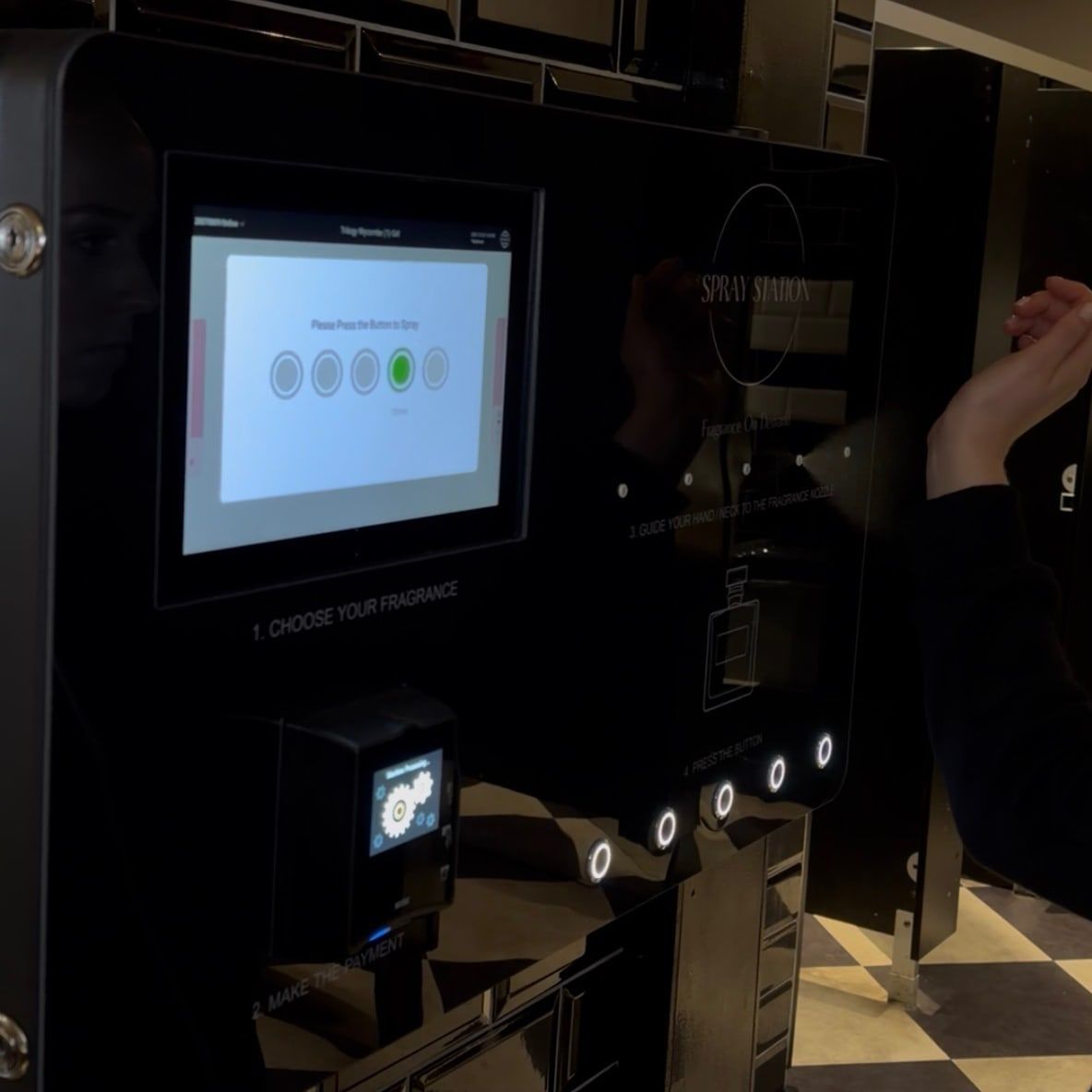 Spray Station wall-mounted perfume vending machine installed in a venue