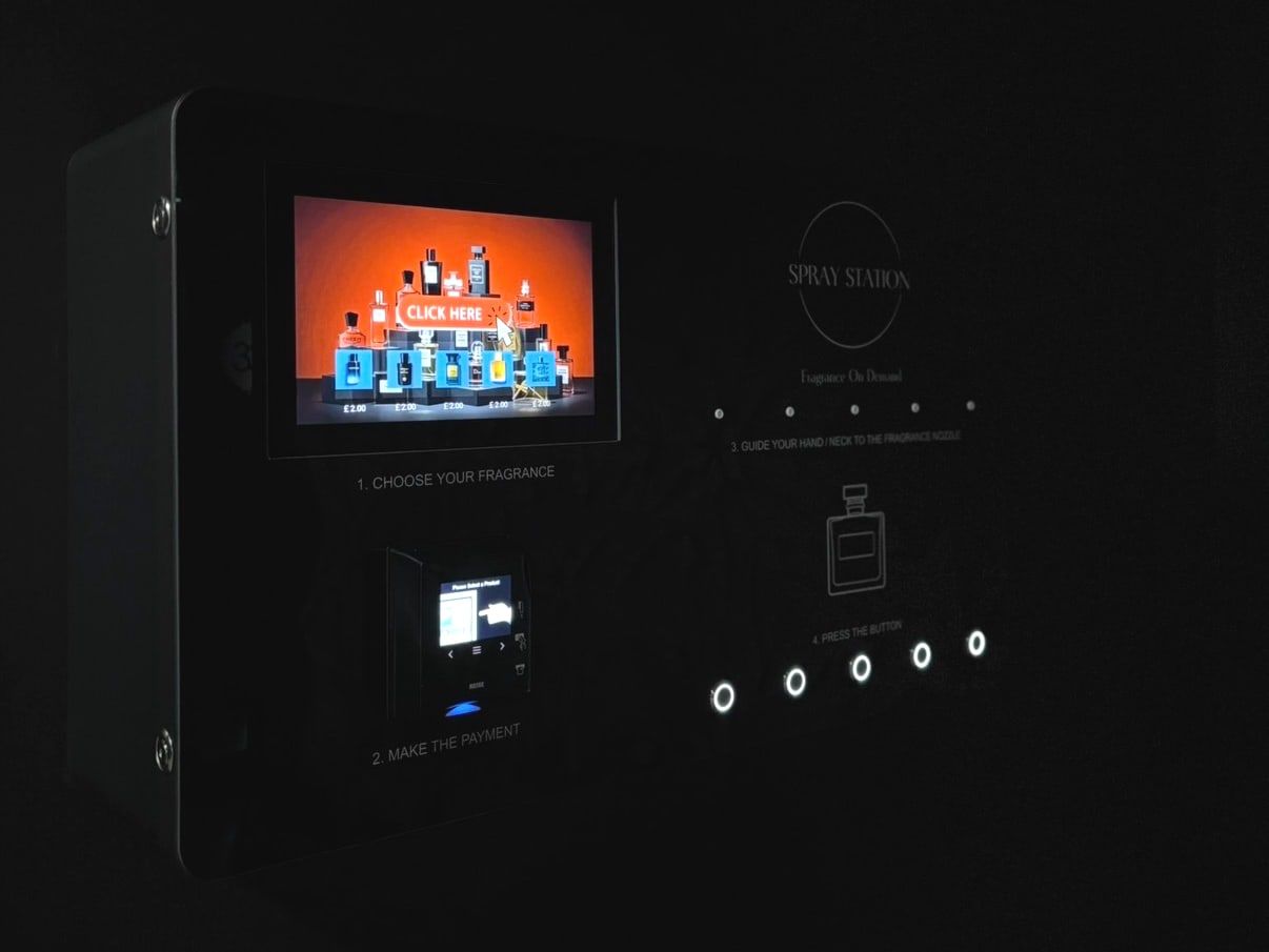 Spray Station wall-mounted perfume vending machine installed in a venue