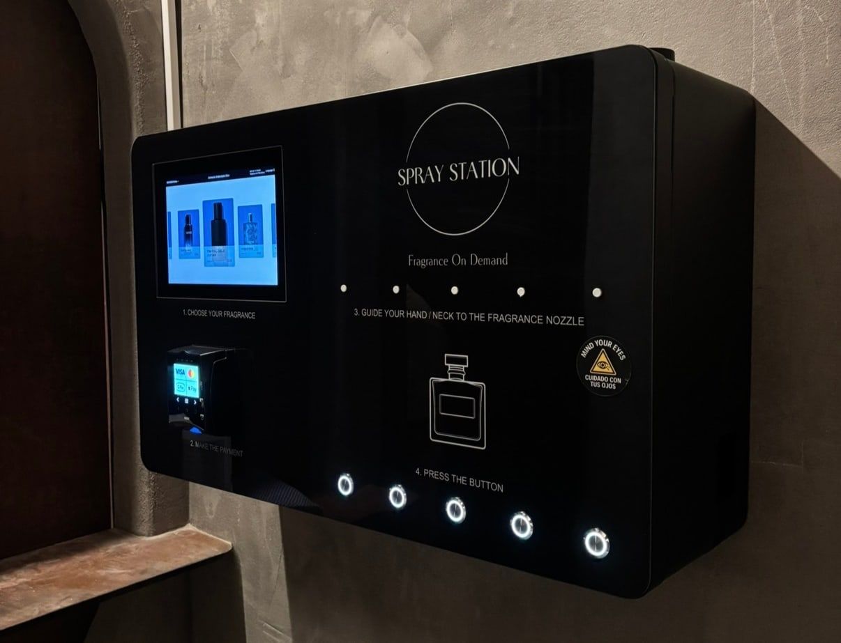 Spray Station wall-mounted perfume vending machine installed in a venue