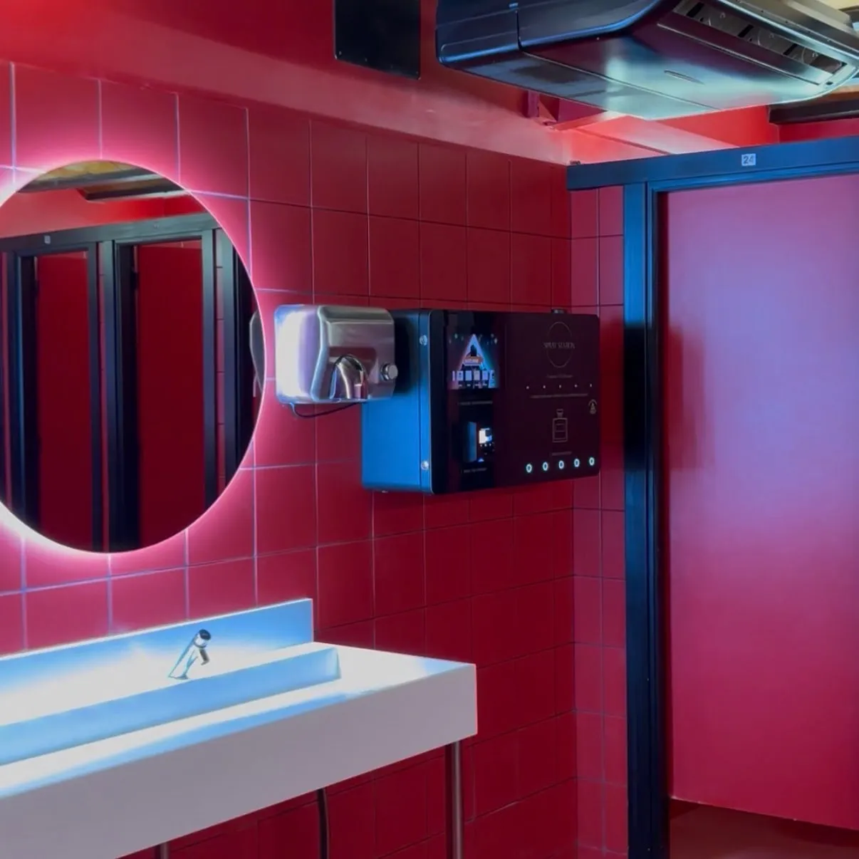 Spray Box perfume vending machine mounted beside the basins in a venue washroom
