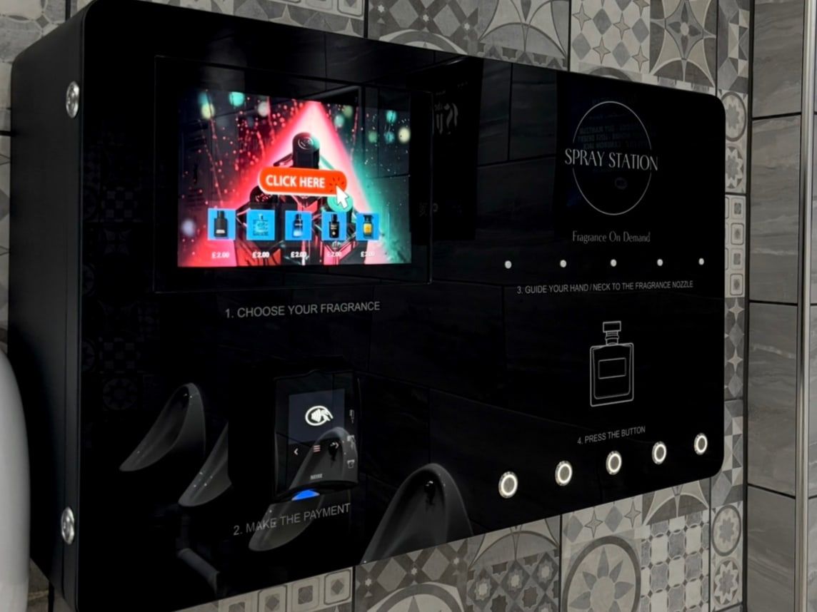 Spray Station wall-mounted perfume vending machine installed in a venue