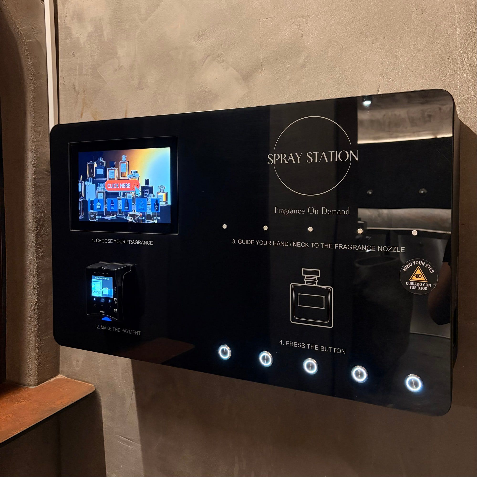 Spray Station wall-mounted perfume vending machine installed in a venue