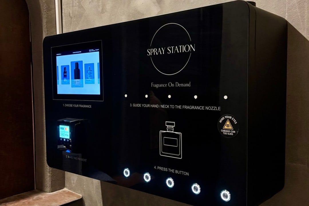 Perfume vending machine fitted into a wall alcove